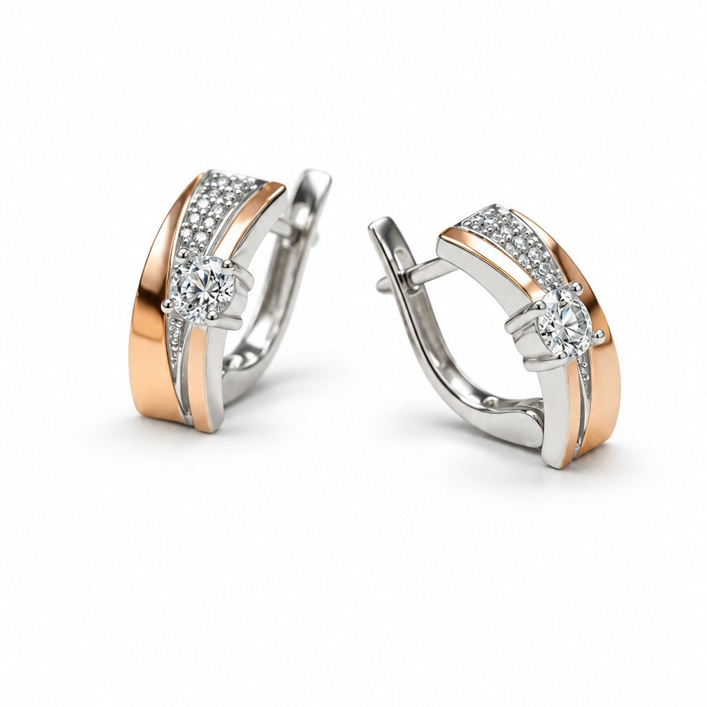     Two-tone silver earrings featuring gold plates and round clear center stones